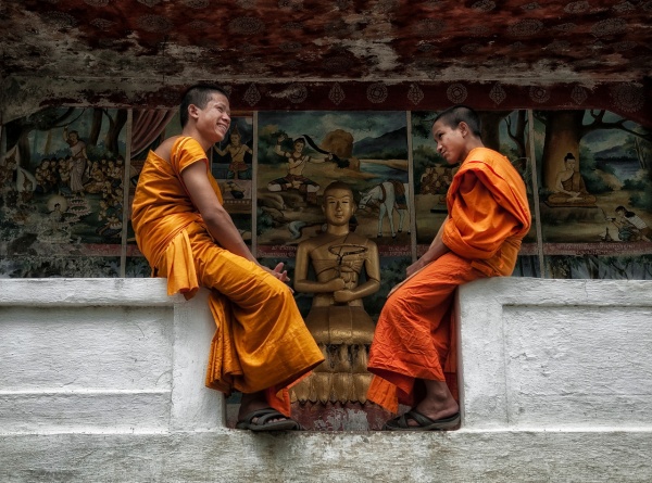 two monks infront of mural,laos-X2